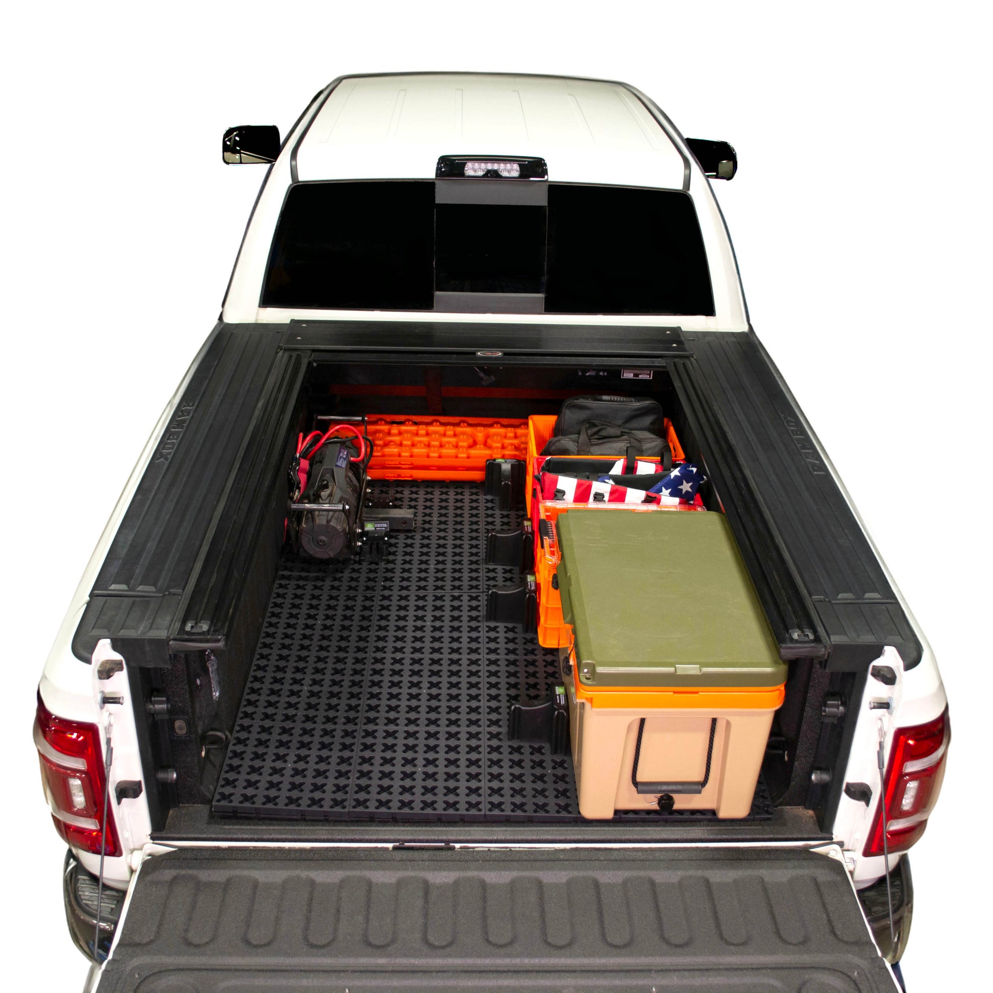 Tmat installed in a Ram 3500 securing a winch, recovery boards, Sidio crates, and a Rtic cooler. 